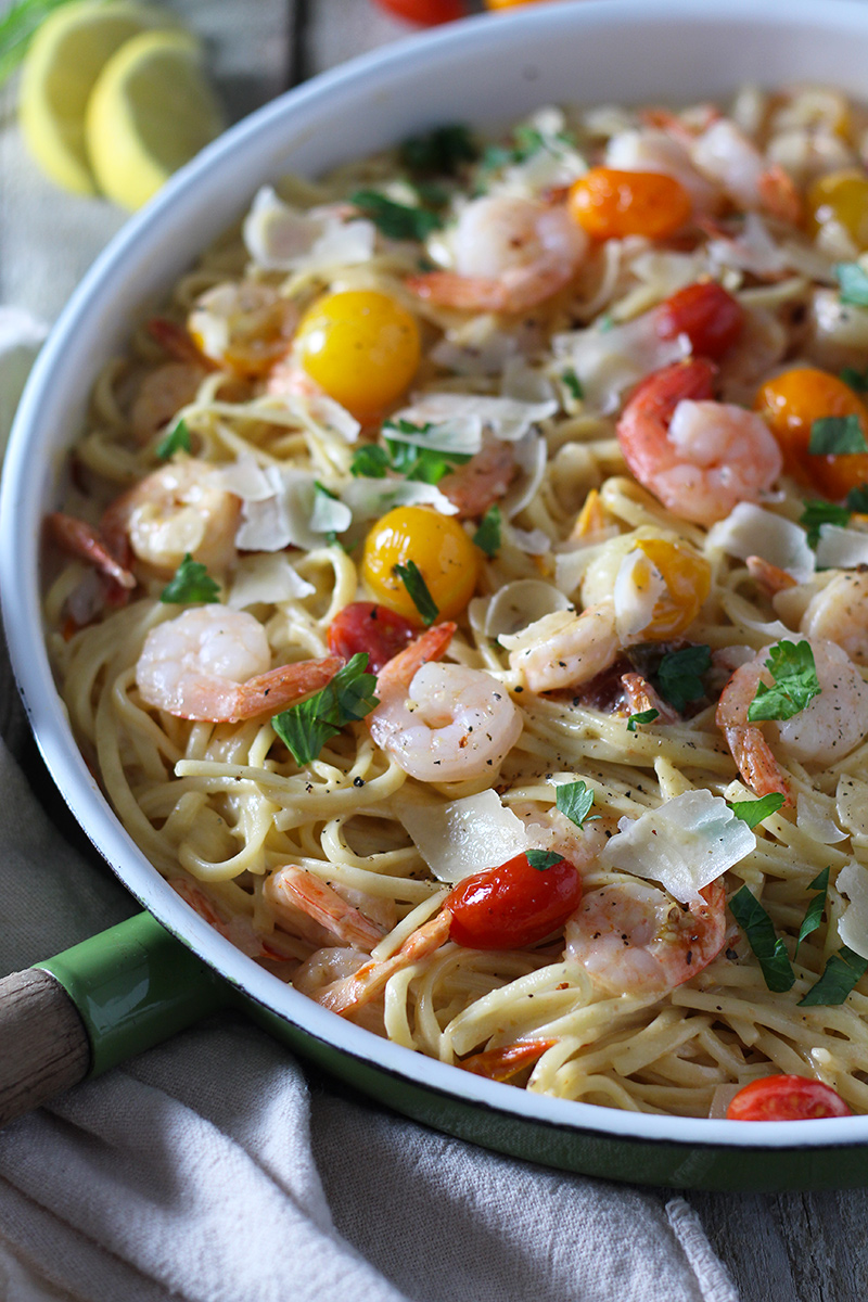 Shrimp Scampi meets alfredo! This delicious pasta is ready in 30 minutes and is packed with flavor from burst tomatoes, garlic, fresh squeezed lemon and parmesan.
