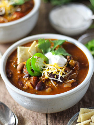 Hearty, easy-to-make chili with a kick! Loaded with five kinds of peppers from sweet to spicy, made with a full can of beer and homemade chili seasoning, and packed with beef and 4 kinds of beans.