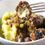 One skillet French Onion Cheese Stuffed Meatballs are the perfect alternative to soup! Meatballs stuffed with Swiss cheese and smothered in perfectly caramelized onion and red wine gravy.
