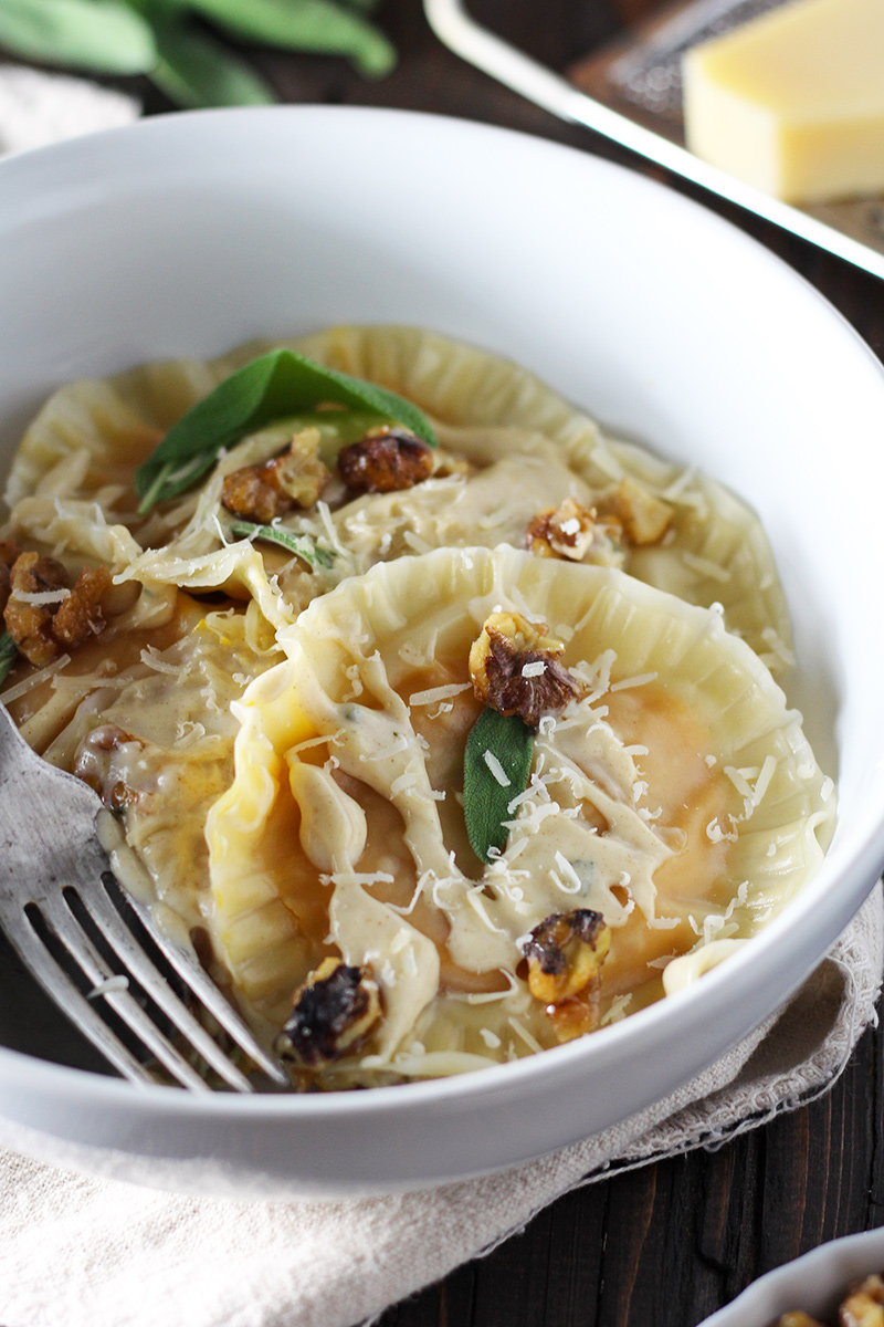 Butternut squash ravioli made super easy with wonton wrappers! Served with creamy and sweet brown butter sage sauce and homemade candied walnuts.