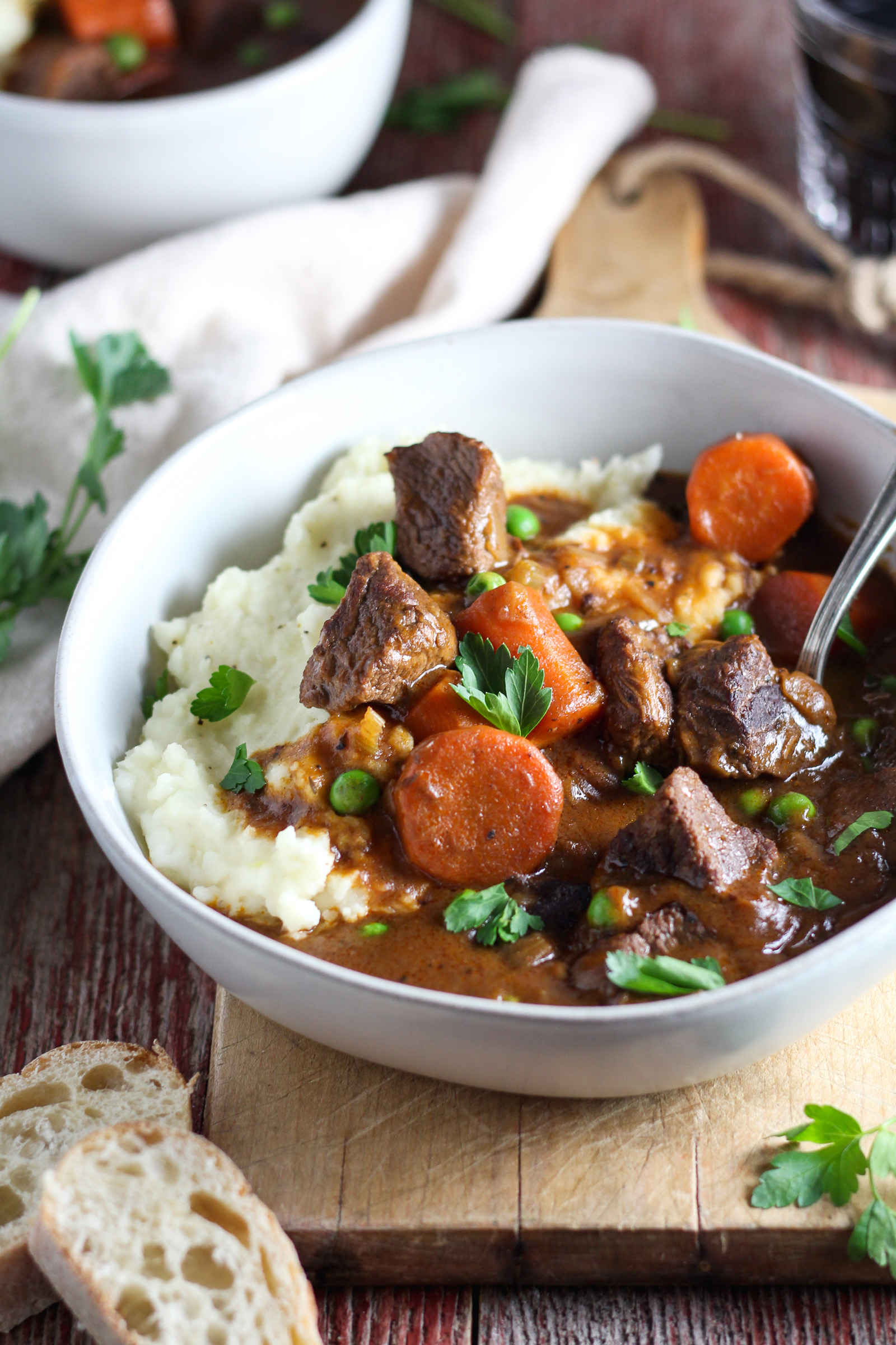 Insanely tender, fall-apart beef, carrots and peas smothered in rich gravy made with Jameson whiskey and Guinness beer. This stew packs incredible flavor and is served over creamy garlic mashed potatoes, making it the ultimate comfort food. Slow cooked in the crockpot, it’s easy to make and perfect for feeding a crowd on St. Patrick’s Day!