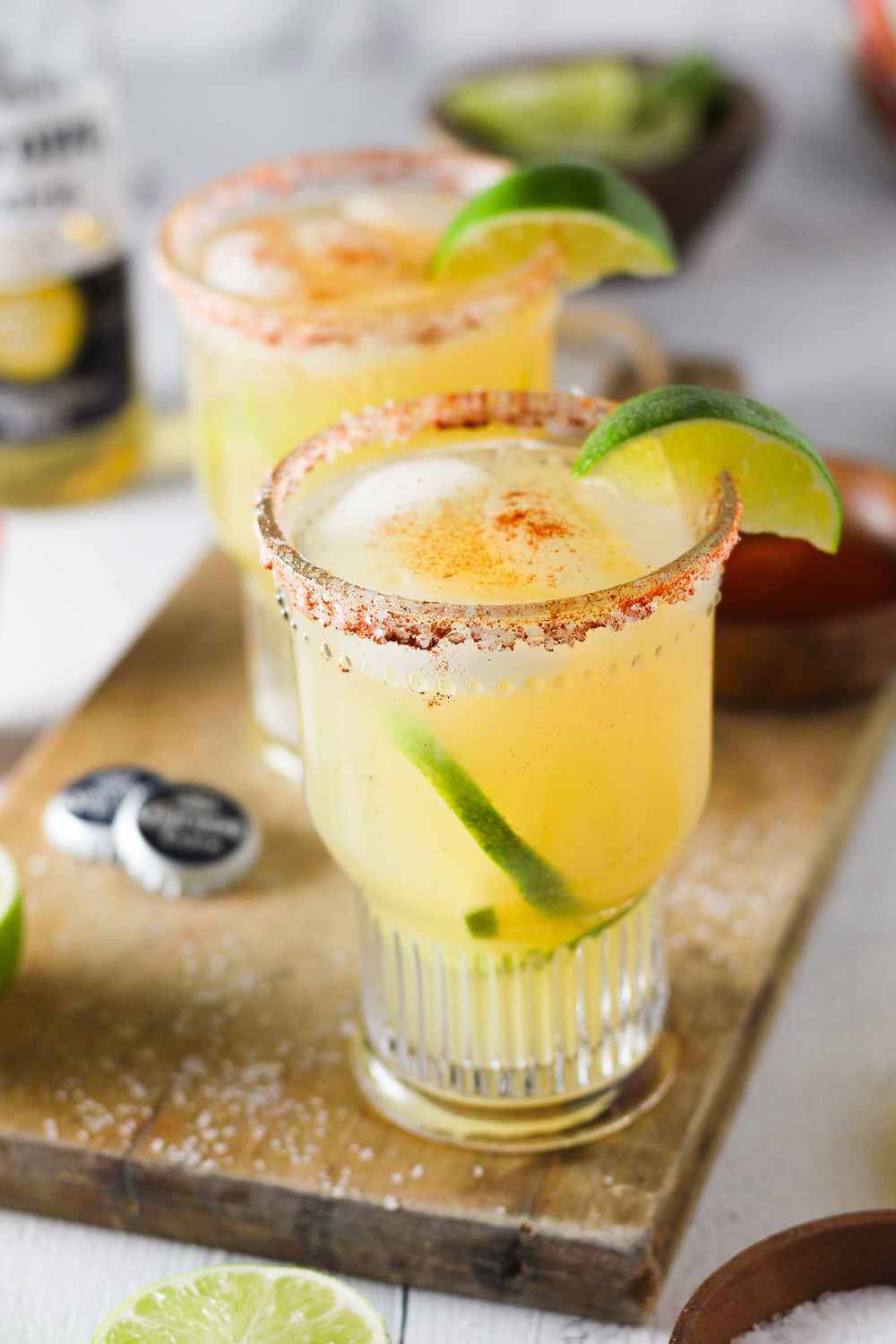 Crisp and refreshing margarita that is perfectly balanced with fresh lemon and lime juice, natural sweetener and tequila then topped off with Corona Extra and served in a glass with a chili-lime salt rim.