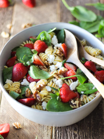 Summer pasta salad that’s perfect for BBQs and parties! This flavor-packed strawberry and goat cheese pasta salad is the perfect combination of pasta, fresh strawberries, baby spinach, tangy goat cheese (or feta), walnuts and homemade lemon poppy seed dressing. It’s a definite crowd pleaser!