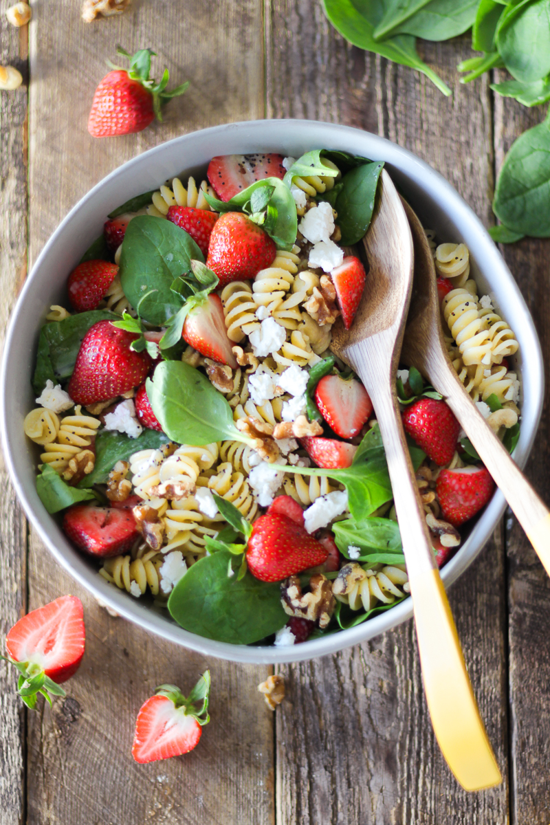 Summer pasta salad that’s perfect for BBQs and parties! This flavor-packed strawberry and goat cheese pasta salad is the perfect combination of pasta, fresh strawberries, baby spinach, tangy goat cheese (or feta), walnuts and homemade lemon poppy seed dressing. It’s a definite crowd pleaser!