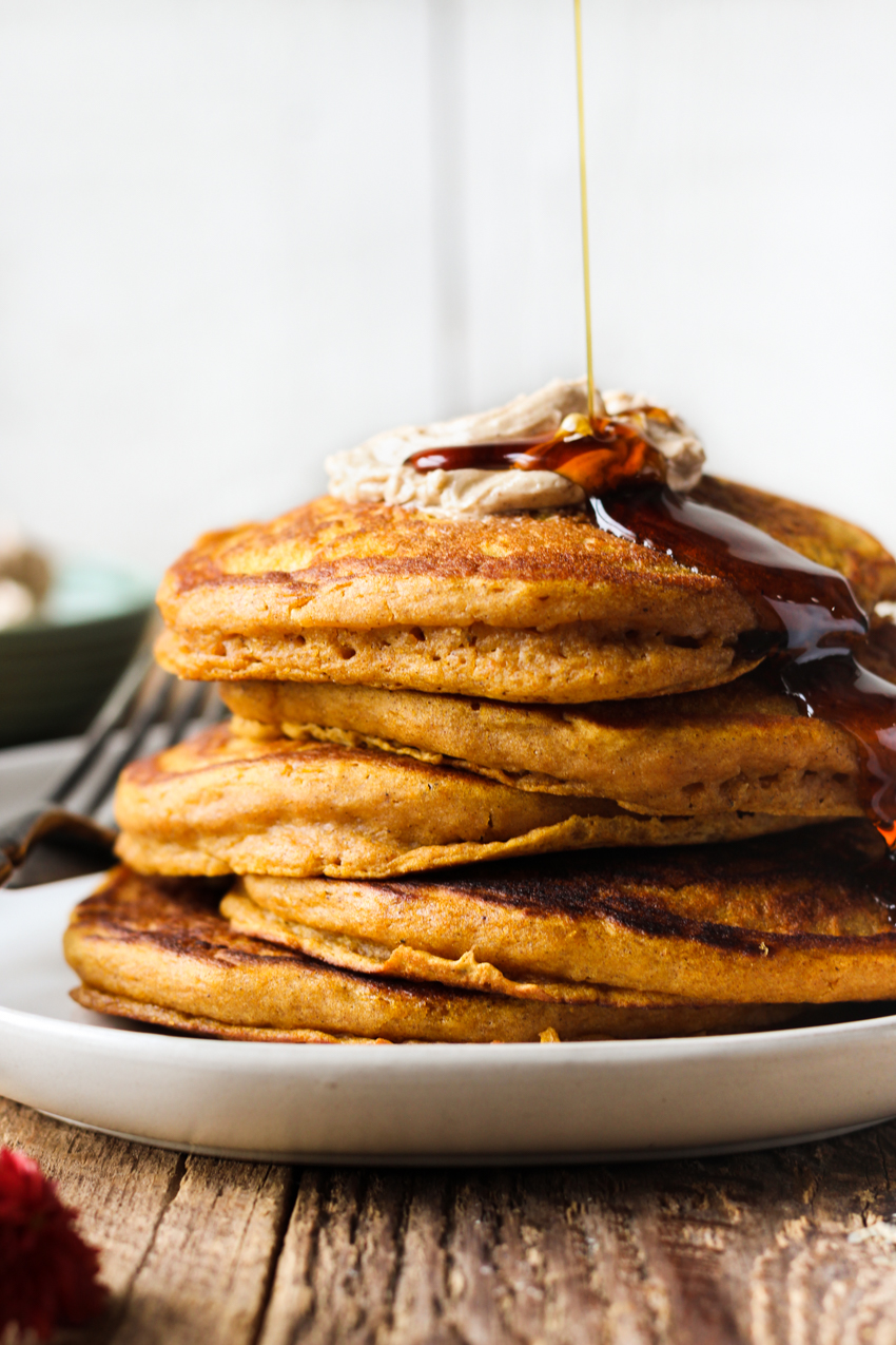 Fluffy pumpkin pancakes with cinnamon honey butter and maple syrup