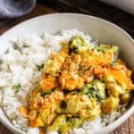 curry chicken and broccoli in a bowl over rice