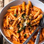 penne alla vodka with a glass of red wine