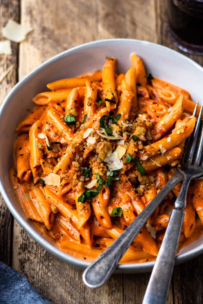 penne alla vodka with a glass of red wine