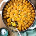 breakfast tater tot casserole with sausage, eggs, and cheese sauce