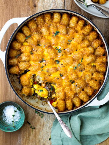 breakfast tater tot casserole with sausage, eggs, and cheese sauce