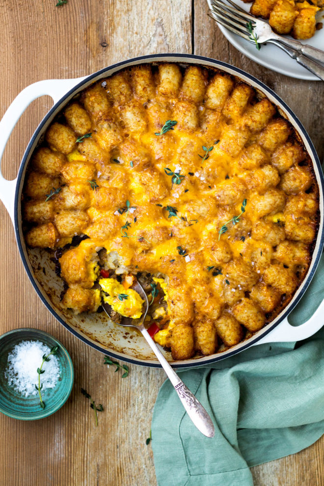 breakfast tater tot casserole with sausage, eggs, and cheese sauce