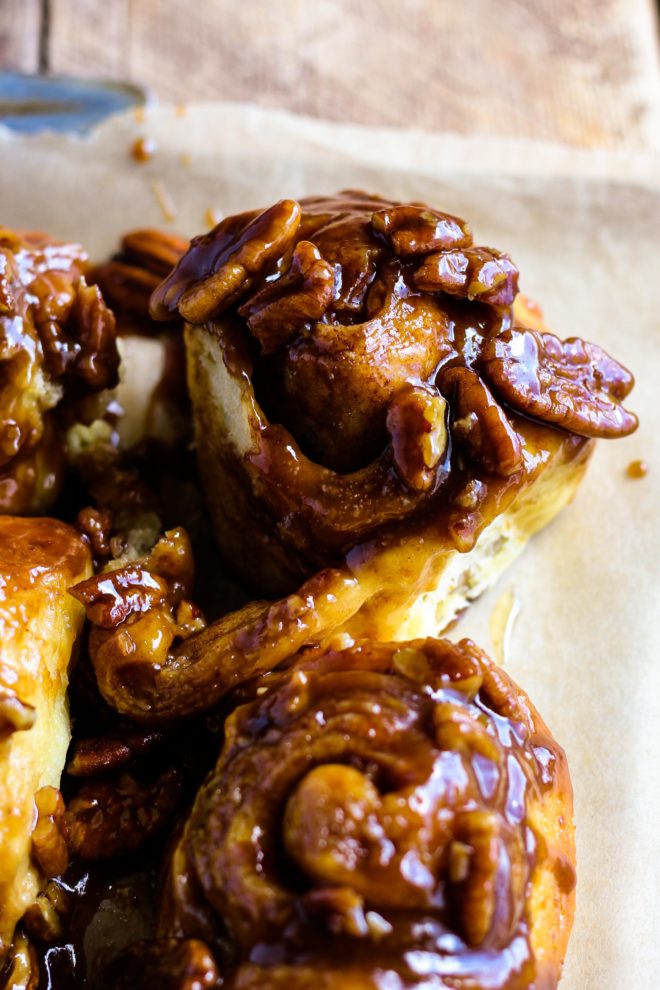 The MOST fluffy, soft, and delicious Caramel Pecan Sticky Buns! Homemade dough sprinkled with cinnamon sugar and baked in gooey caramel pecan sauce. This recipe includes the option to make them overnight so they’re warm and fresh for breakfast.