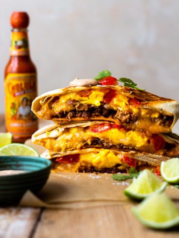 Flour tortilla stuffed with seasoned pork, crispy hash browns, fluffy scrambled eggs, lots of cheese, fresh tomatoes and the MOST delicious Creamy Jalapeño Sauce that tastes just like Taco Bell quesadilla sauce!! Grill the Breakfast Crunchwrap to melty, golden perfection then devour.