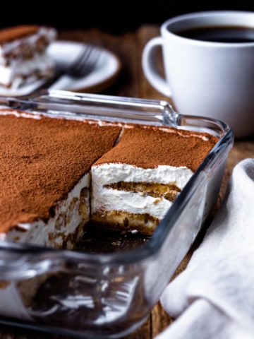 Espresso and coffee liqueur dipped ladyfingers get layered with creamy, fluffy, lightly sweetened mascarpone whipped cream and dusted with rich cocoa powder. This easy, fresh, super delicious no-bake Italian dessert has all the best Tiramisu flavors but without raw eggs.