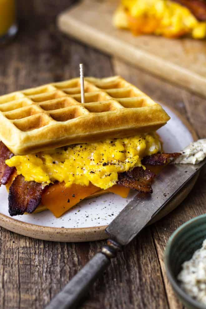 fluffy waffles with eggs, bacon and cheese sandwich