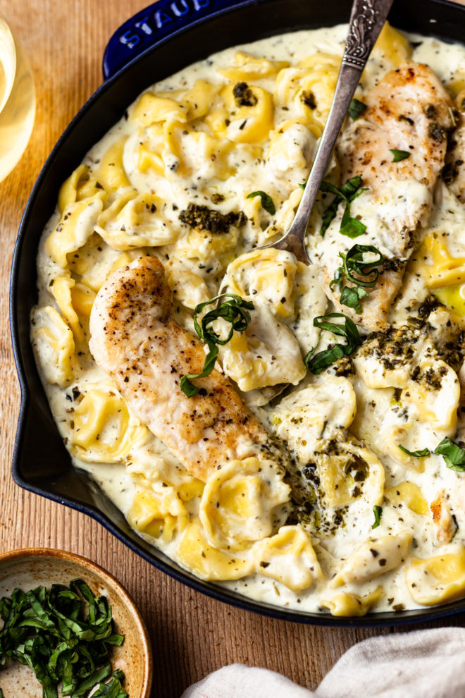 Most delicious parmesan cream sauce mixed with basil pesto and served with cheese tortellini and perfectly seared chicken. Easy and insanely flavorful dinner that's ready in 30 minutes!
