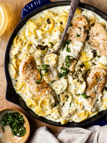 Most delicious parmesan cream sauce mixed with basil pesto and served with cheese tortellini and perfectly seared chicken. Easy and insanely flavorful dinner that's ready in 30 minutes!