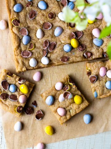 Crispy around the edges and chewy, gooey and buttery on the inside! Chocolate Easter Egg Cookie Bars are an easy to make, fun Easter treat that are studded with Cadbury Milk Chocolate Mini Eggs! These cookie bars are also a good way to use up any leftover chocolate Easter candy! Just add some of your favorite candy to the dough, such as M&M's or chocolate caramels! So so good!
