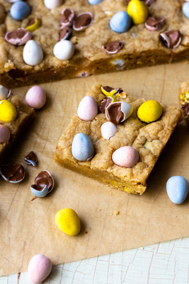 Crispy around the edges and chewy, gooey and buttery on the inside! Chocolate Easter Egg Cookie Bars are an easy to make, fun Easter treat that are studded with Cadbury Milk Chocolate Mini Eggs! These cookie bars are also a good way to use up any leftover chocolate Easter candy! Just add some of your favorite candy to the dough, such as M&M's or chocolate caramels! So so good!