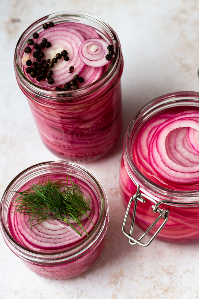 Quick pickled onions are so easy to make and crazy flavorful! All you need is 5 simple ingredients and 10 minutes of time - no canning required! They are a a staple in our home. I always keep a jar or two easily accessible in the fridge. Quick pickled onions add so much flavor to your favorite foods - every kind of taco, burgers, brats, grain bowls and more!
