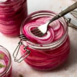 Quick pickled onions are so easy to make and crazy flavorful! All you need is 5 simple ingredients and 10 minutes of time - no canning required! They are a a staple in our home. I always keep a jar or two easily accessible in the fridge. Quick pickled onions add so much flavor to your favorite foods - every kind of taco, burgers, brats, grain bowls and more!