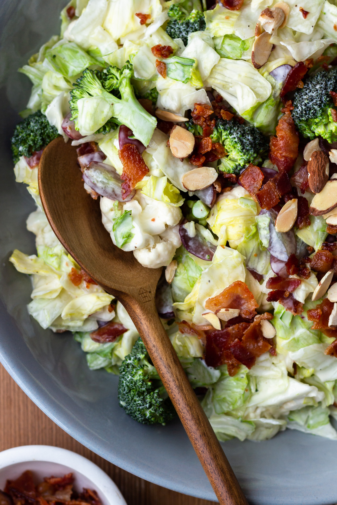 Easy and delicious side salad packed with veggies, bacon, grapes and almonds, then drizzled with a homemade, sweet, creamy dressing. Both adults and kids devour this salad! It’s perfect for a BBQ or quick weeknight side dish. 
