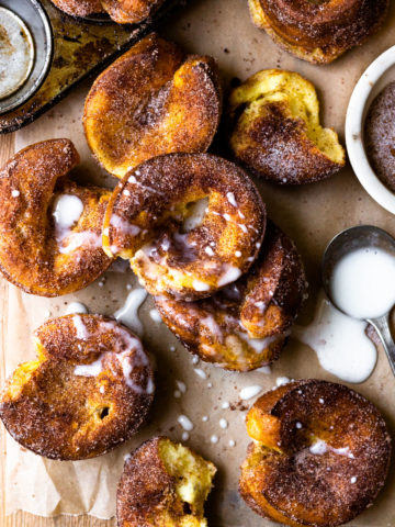 Cinnamon Sugar Churro Popovers are super easy to make and popping with flavor! All you need is 10 minutes to mix up the batter, then bake in a muffin tin until golden, puffed perfection. Brush the warm popovers with butter, sprinkle with cinnamon sugar and serve with homemade vanilla icing. So amazing!!