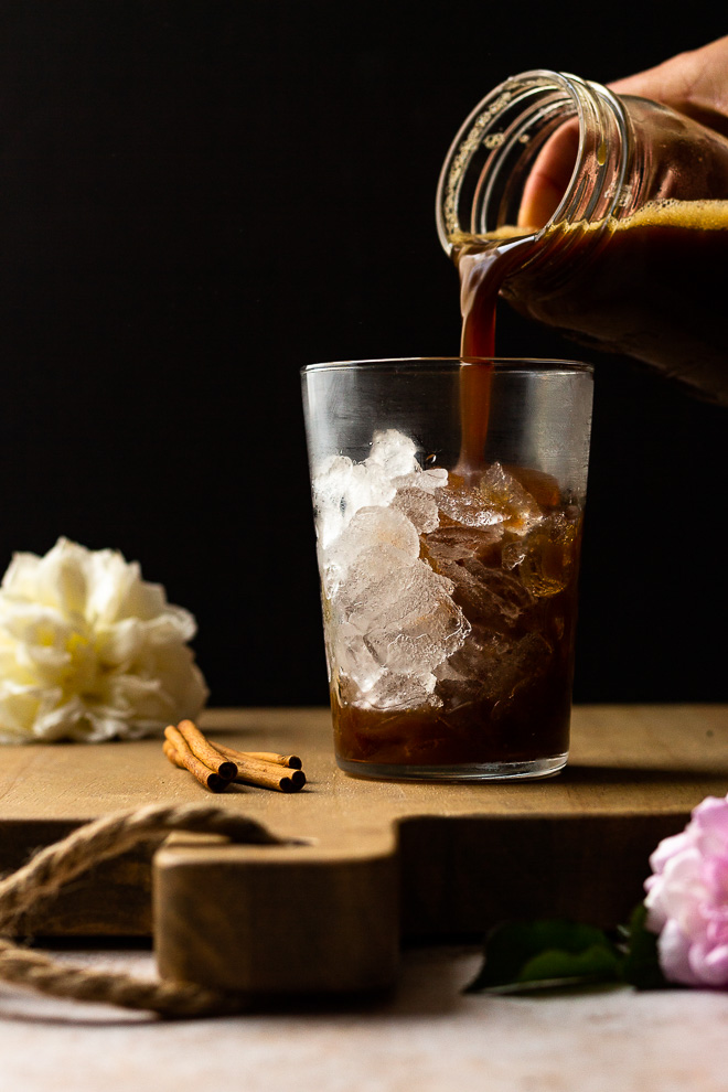 pouring shaken brown sugar syrup and espresso over ice