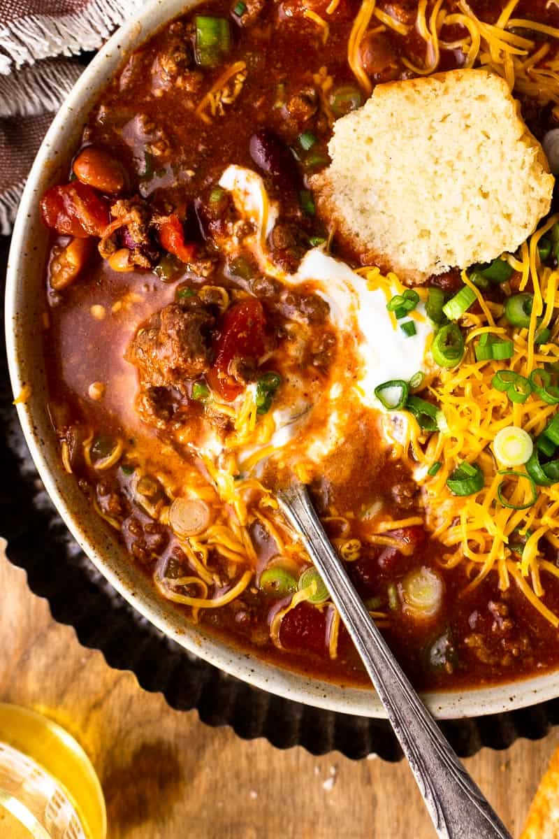 venison chili in a bowl with toppings