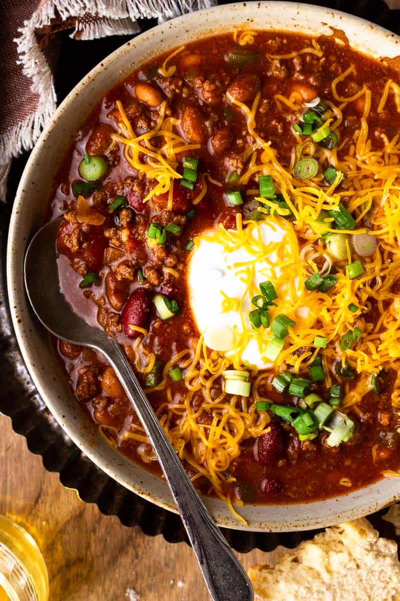 venison chili with sour cream, cheese and onions