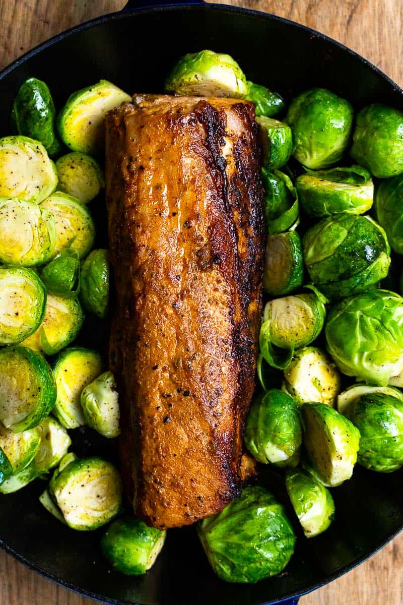 seared pork tenderloin in a cast iron with brussel sprouts