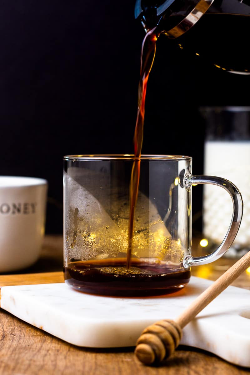 Pouring hot espresso into a mug