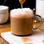 drizzling honey over a hot miel in a mug