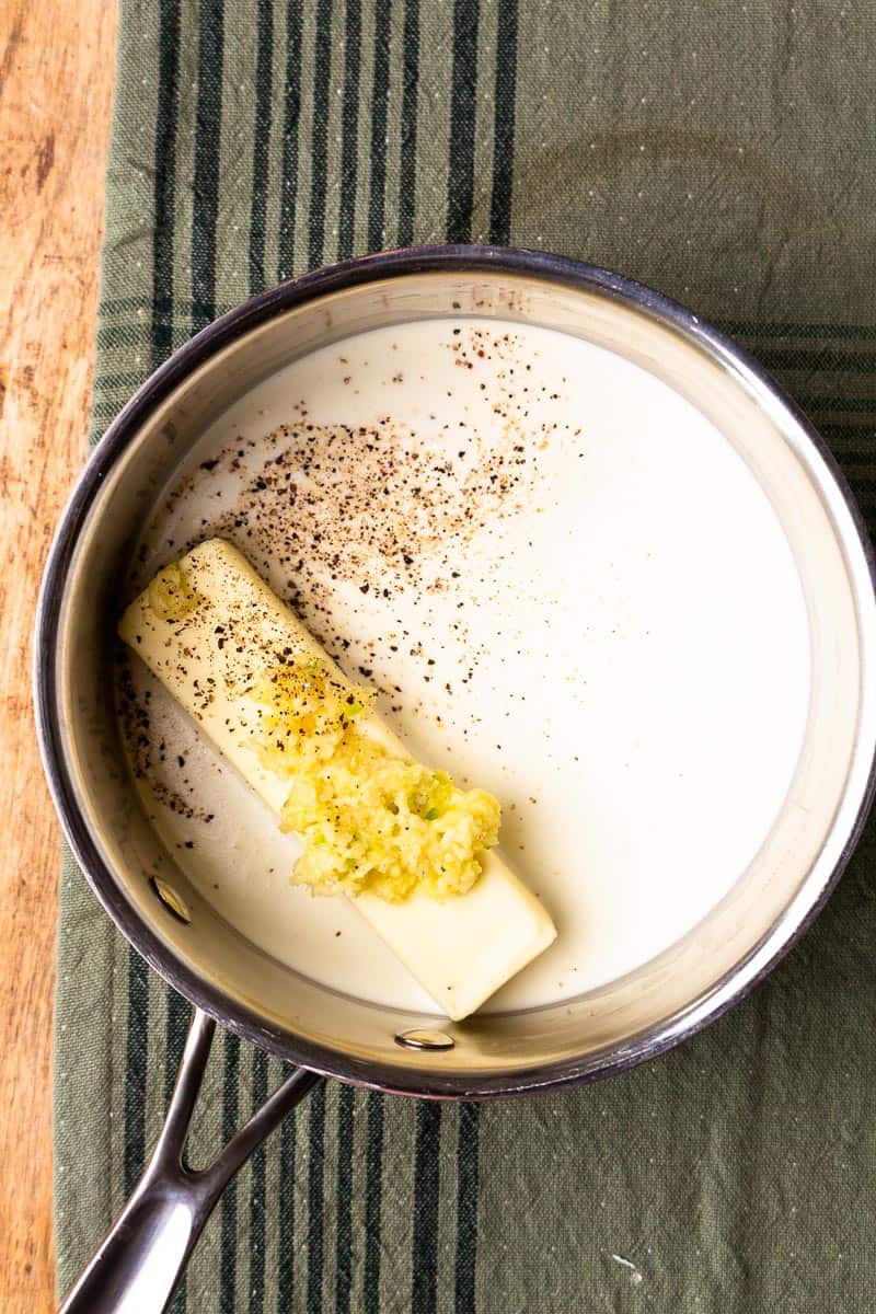 saucepan with butter, milk, cream and garlic