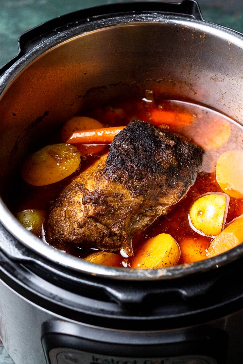 pork shoulder, carrots, potatoes and broth in Instant Pot