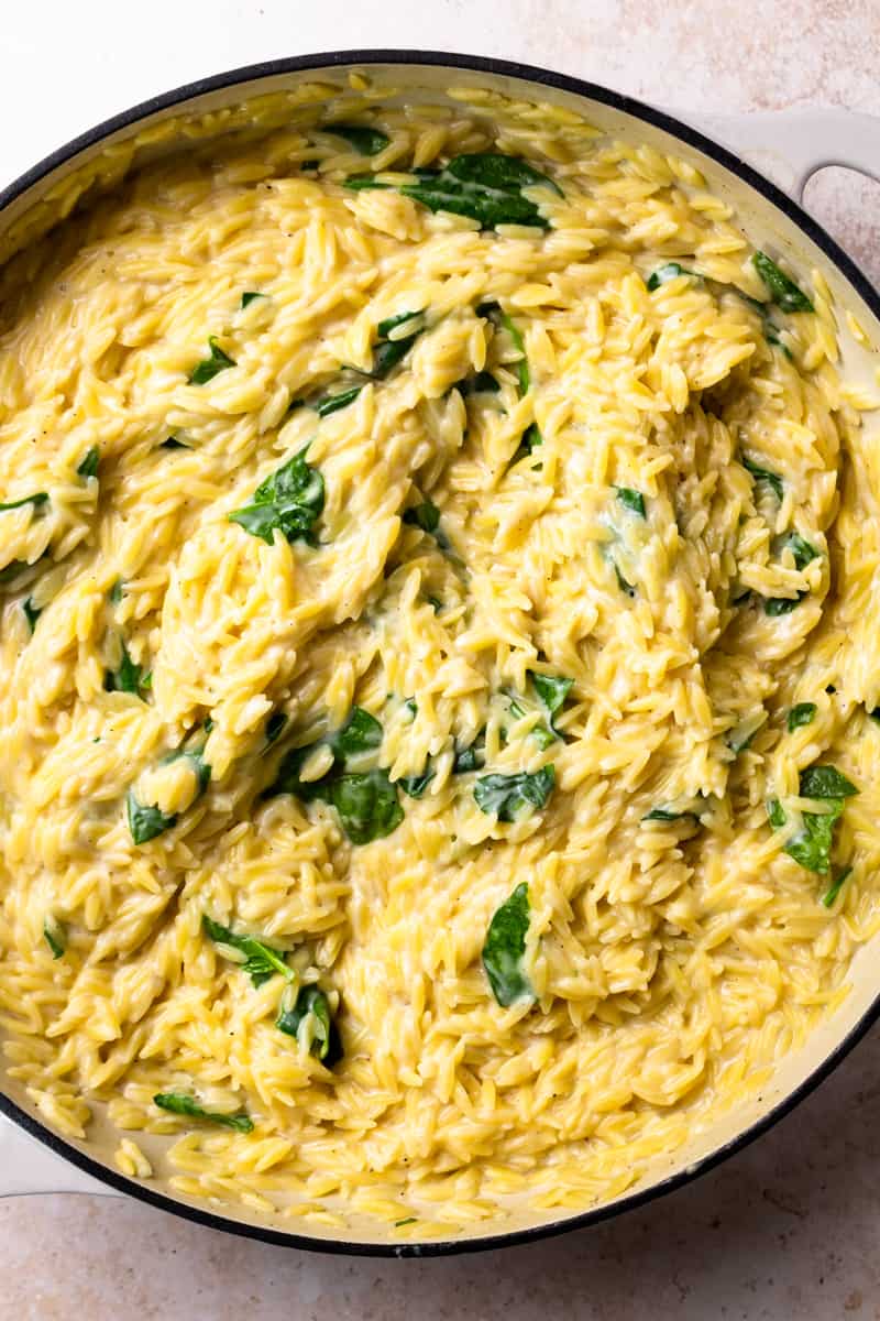 creamy spinach orzo in a skillet