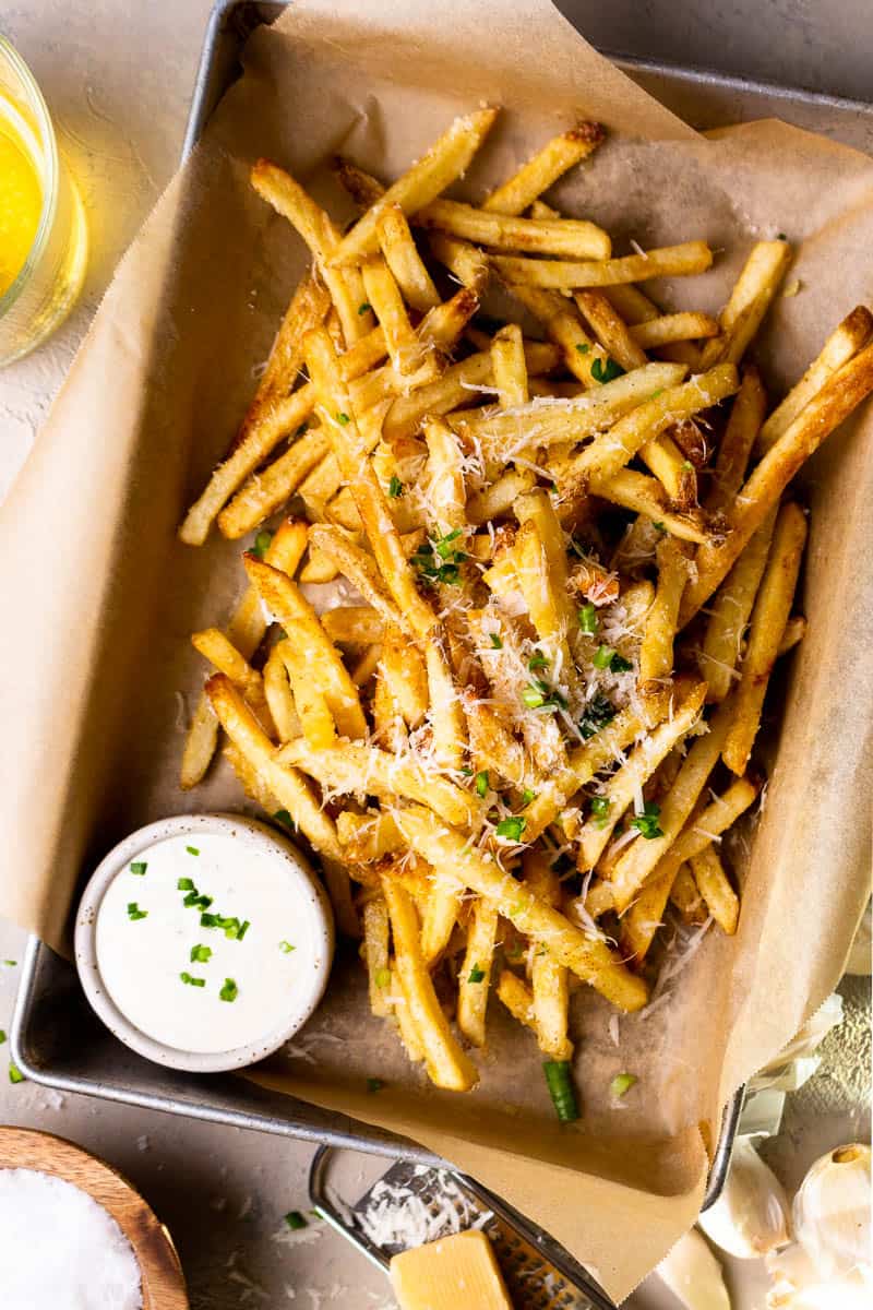 garlic parmesan French fries in a basket with ranch