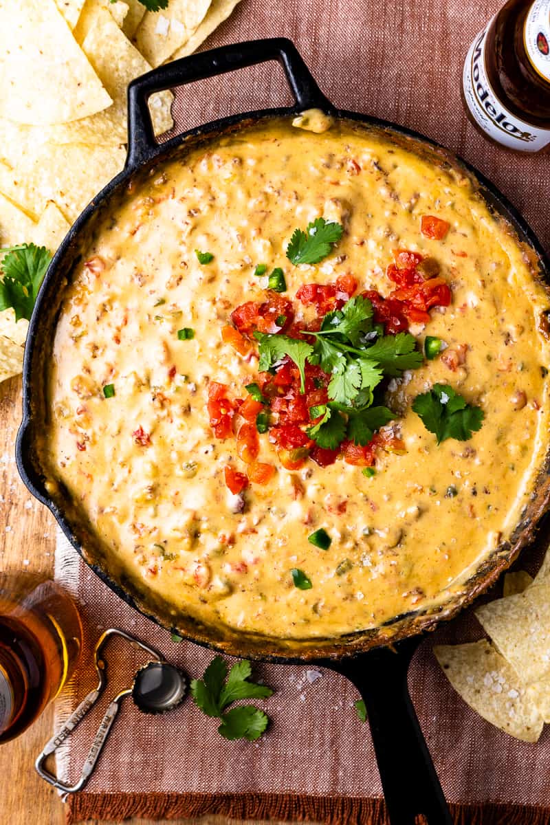 smoked queso topped with tomatoes and cilantro