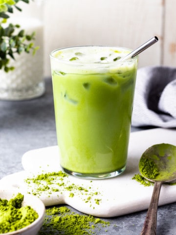 iced matcha latte in a glass with a straw