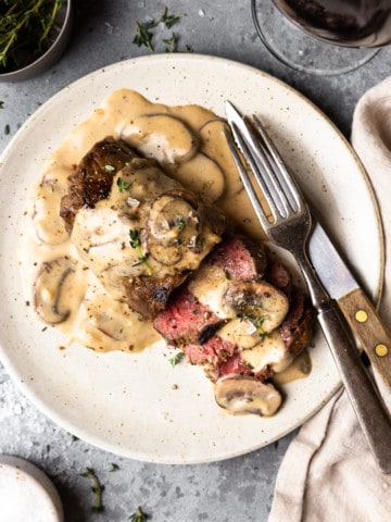 venison steak covered in mushroom cream sauce