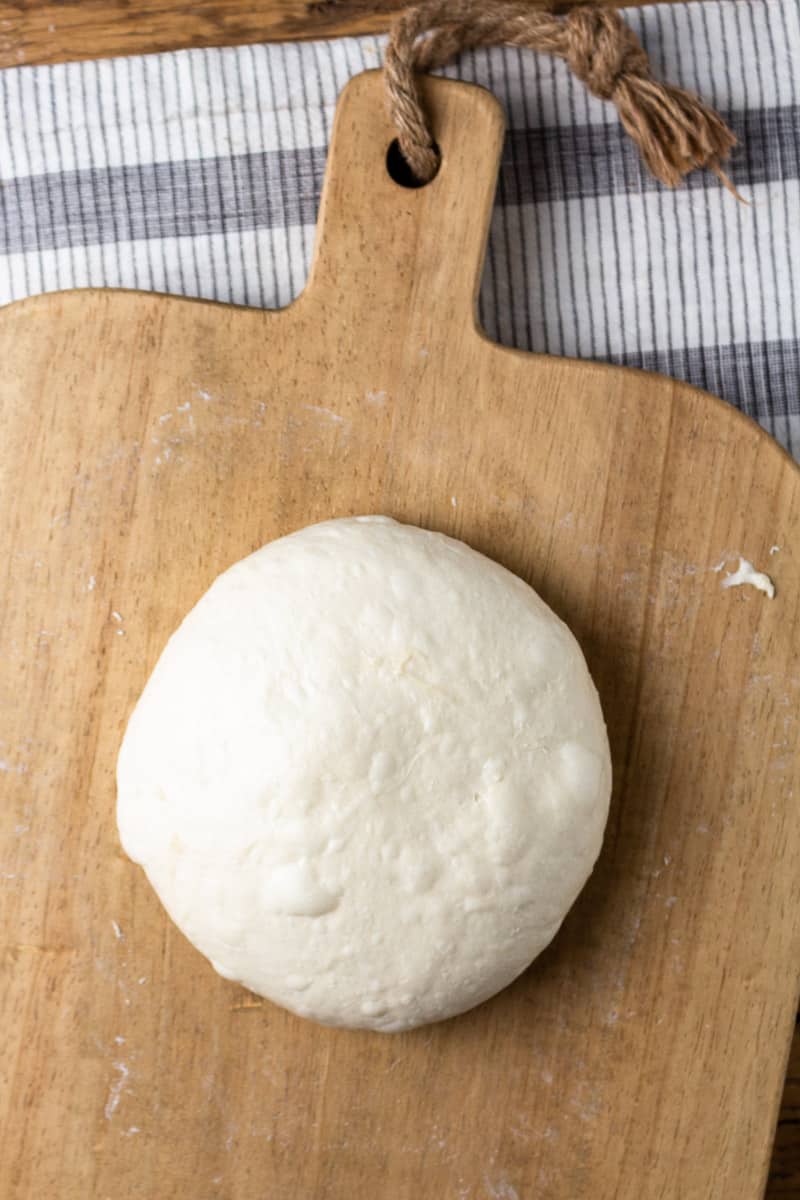 shaped sourdough ball on a cutting board