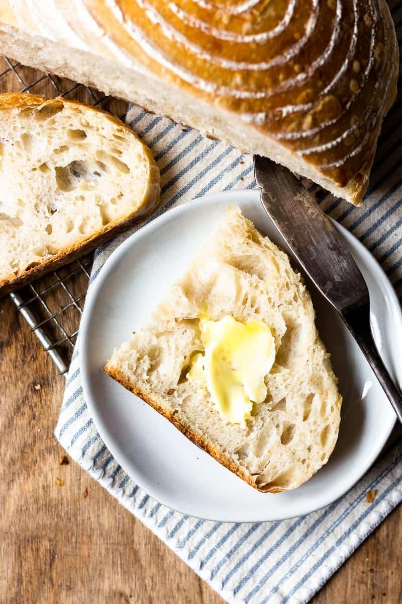 slice of sourdough bread on a plate with butter