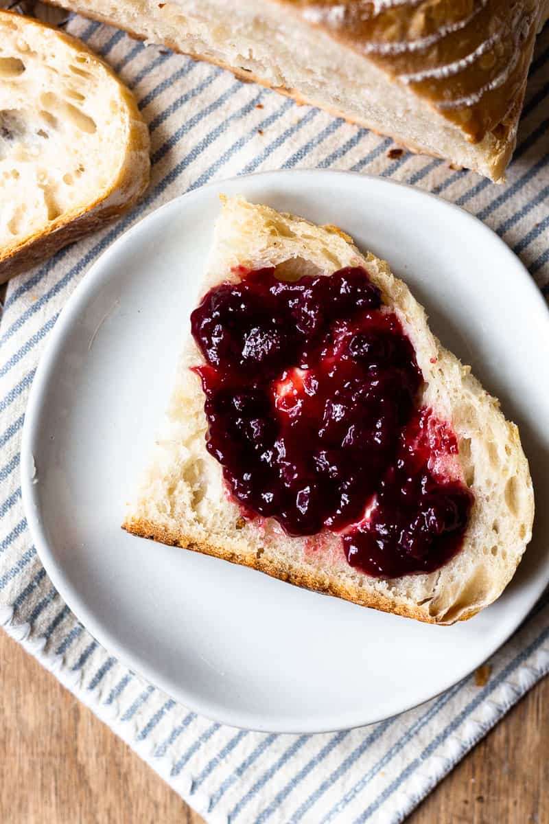 slice of sourdough bread on a plate with jam