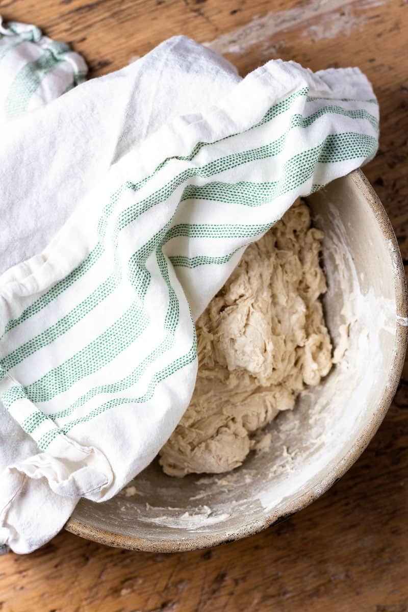 sourdough in a bowl covered with a towel