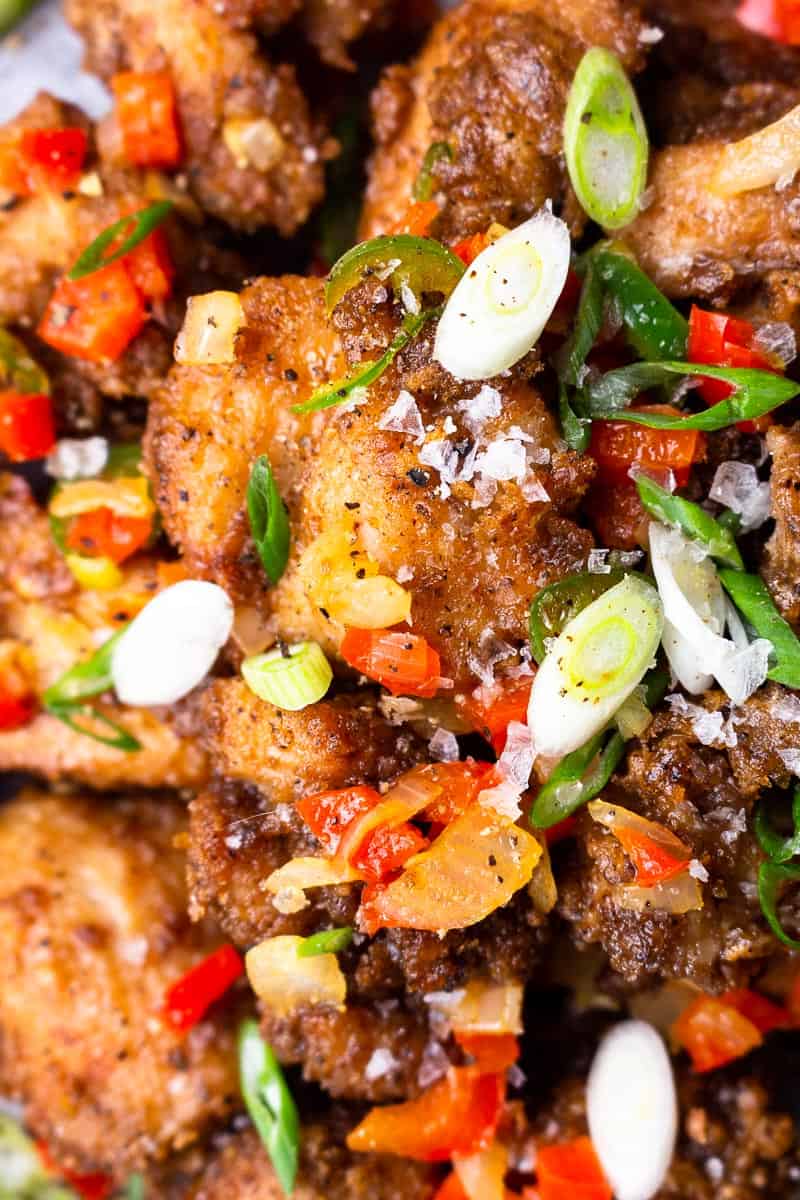 bite size fried chicken pieces with fried onion and peppers