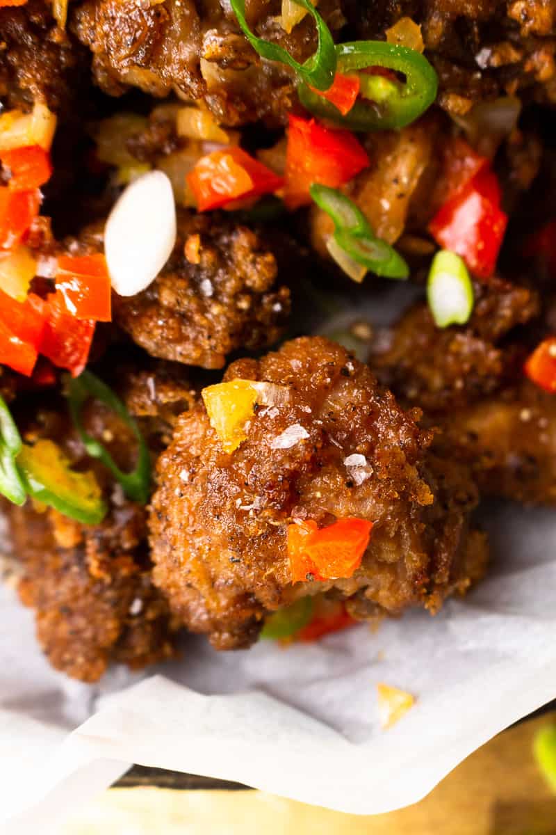 bite size fried chicken pieces with fried onion and peppers