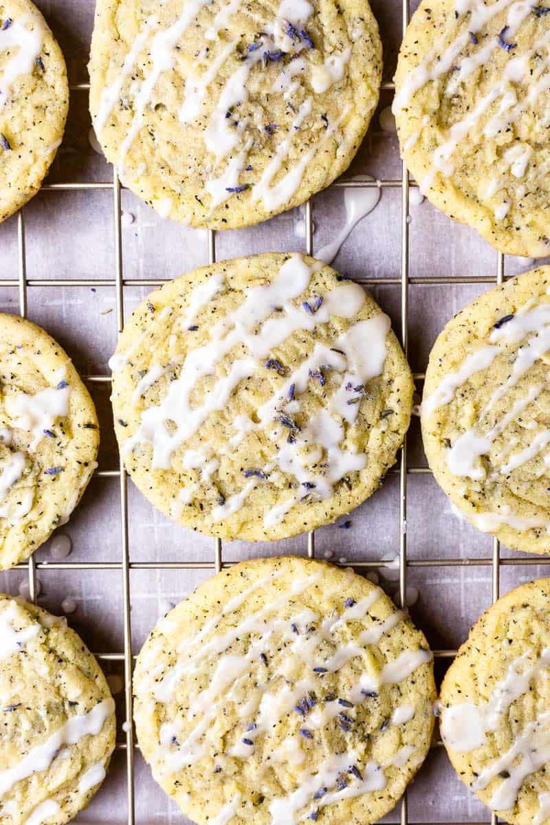 lavender earl grey cookies on a cooling rack after being drizzled with lemon glaze