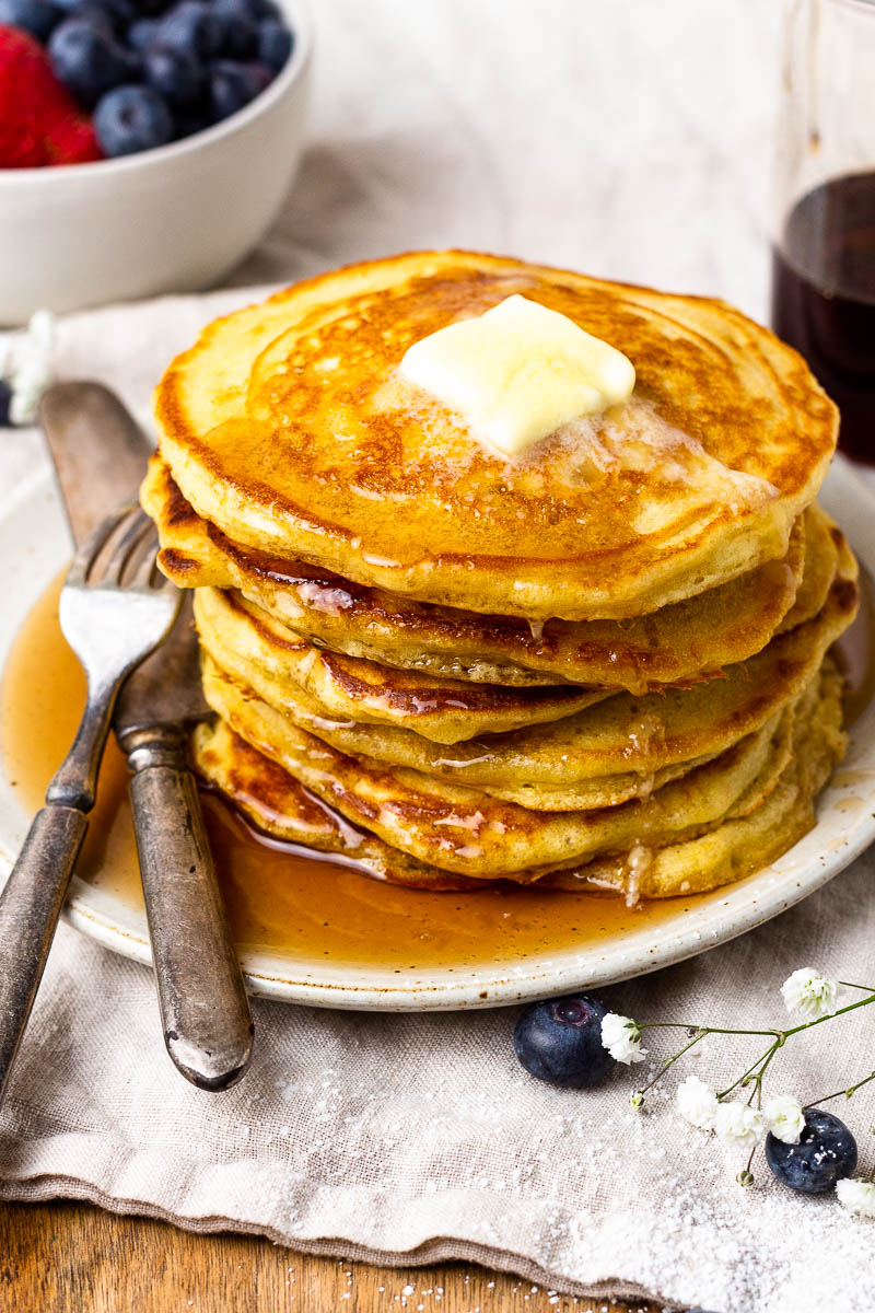 sourdough pancakes on a plate with syrup and butter