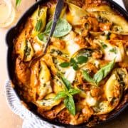 cheese stuffed pasta shells in a skillet with vodka sauce