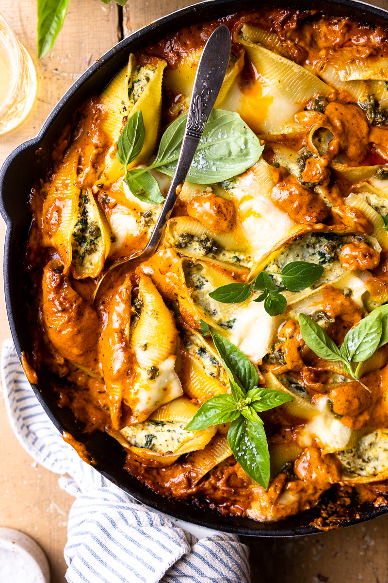 cheese stuffed pasta shells in a skillet with vodka sauce
